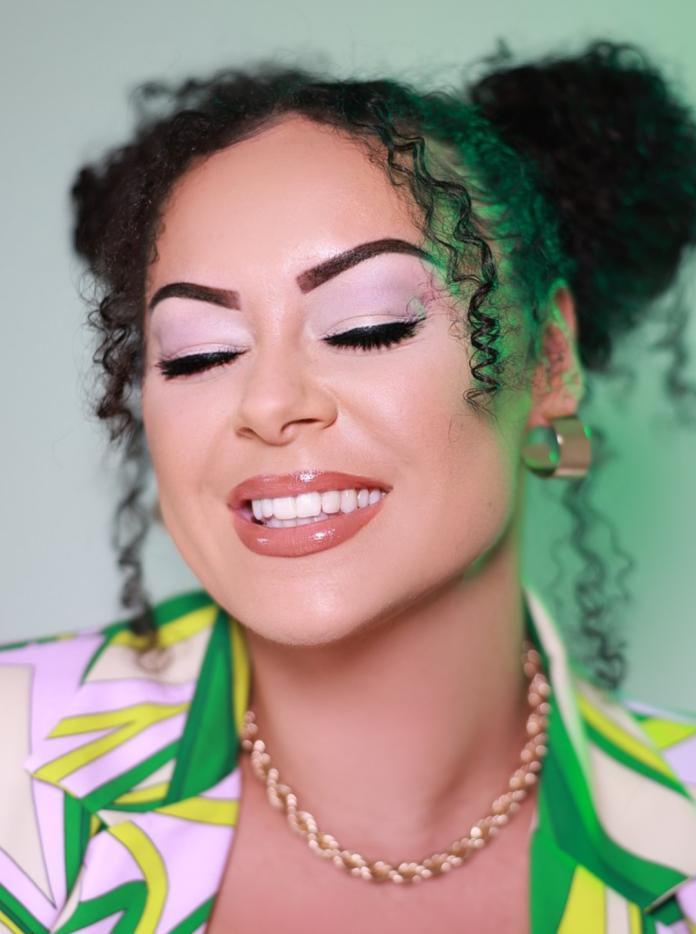 close up of Aleighcia's face, smiling with eyes closed