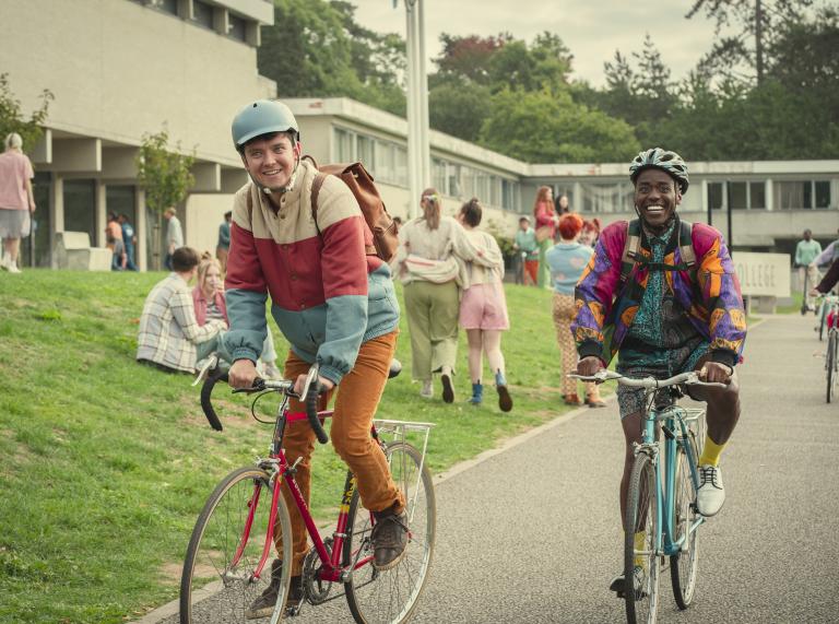 Eric and Otis on bikes outside Cavendish College