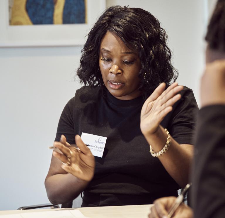 two women having a discussion at a TV accelerator session.