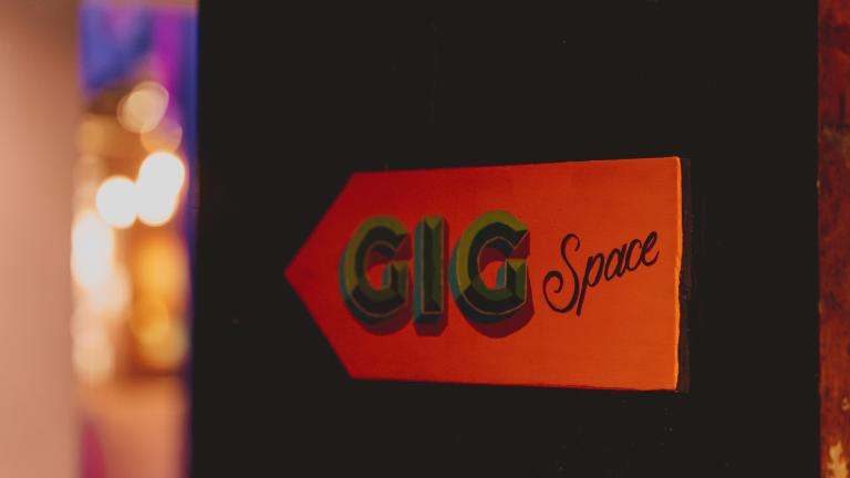 red sign with black writing saying 'GiG Space'