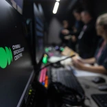 Control room at Cymru Broadcast Centre with staff working at computers and equipment nearby