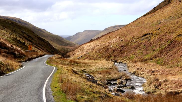 a road winding down a valley in the Cambrian mountains