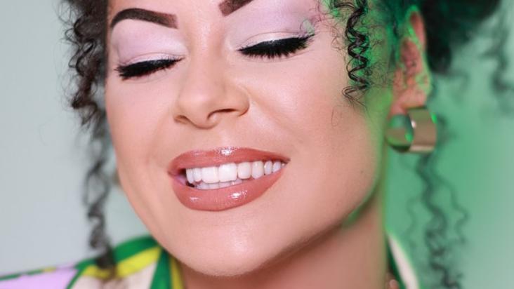 close up of Aleighcia's face, smiling with eyes closed